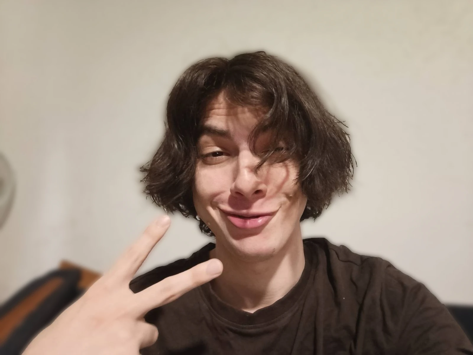 Alex pulling a goofy face and holding up a peace sign